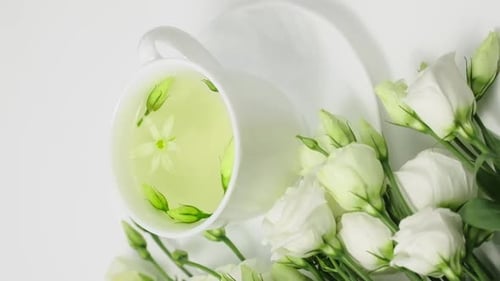 Cup of Tea with White Roses Arrangement