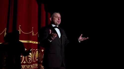 Male host talking on stage.