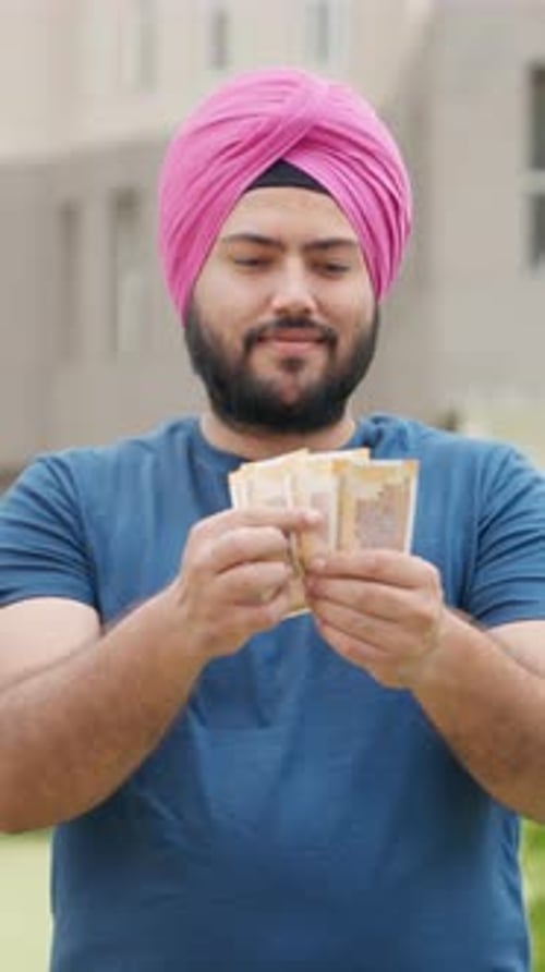 Man in Turban Counts His Money