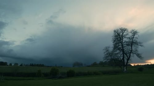 Summer storm clouds approaching in evening dusk with rain