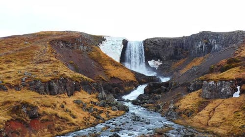 Huge Scenic Waterfall in Iceland Pure Glacier River in Mountains Autumn Colours Aerial View