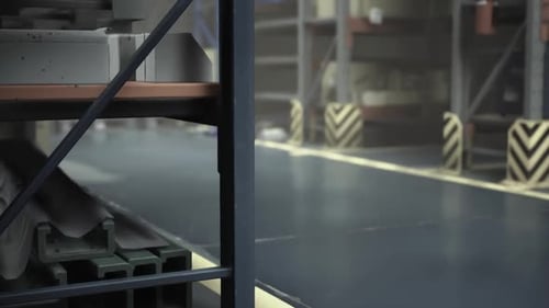 A Quiet Warehouse Scene Reveals Neatly Arranged Shelves and a Pristine Floor