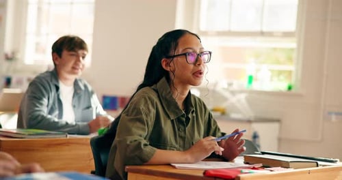 Teen Students in Classroom Listening and Raising Hands
