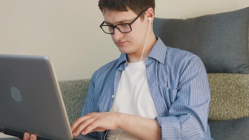 Young Adult Using Laptop Computer at Home