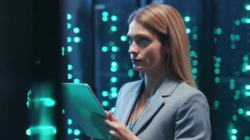 Woman Uses Tablet in Data Center Server Room