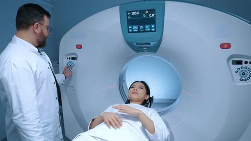 Woman Undergoes Medical Scan as Doctor Operates Machine