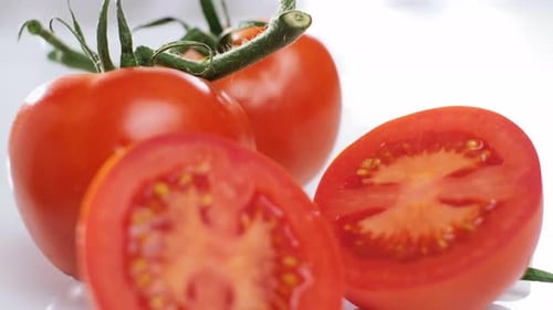Healthy food, Fresh tomatoes displayed on white background, Tracking out shot