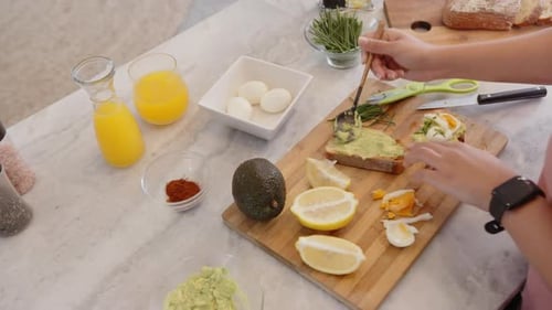 Preparing Avocado Toast with Eggs and Lemon