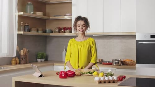 Smiling Woman with Fresh Food in Modern Kitchen
