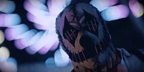Sinister Masked Figure in Front of a Ferris Wheel
