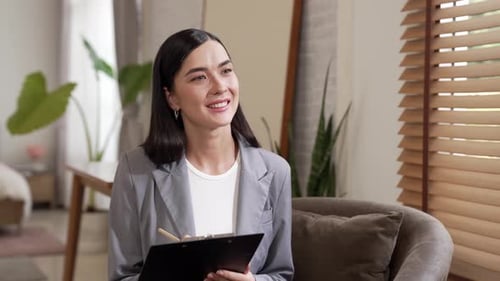 Two women meet indoors for consultation, smiling