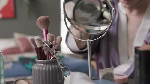Queer Man Applying Makeup in Backstage Room