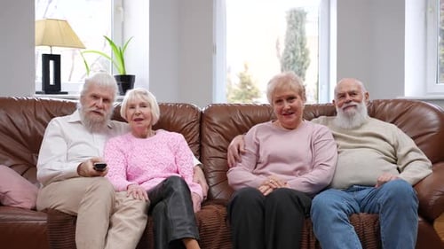 Senior Couples Relaxing Together on Sofa at Home