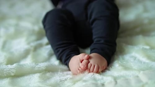 Close up view of baby feet. Newborn baby fingers.