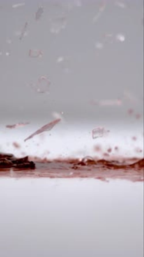 Glass with Red Wine Crashing to the Ground in Slow Motion in Vertical