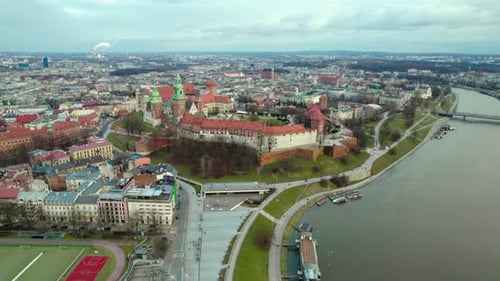 Establishing dolly moving forward aerial over Wawel Royal Castle by the river Vistula in the city of