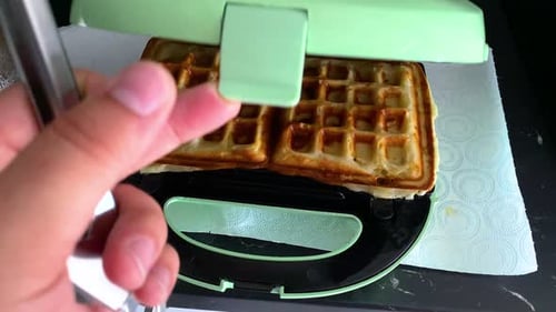 Fresh Waffle Emerging from Waffle Maker