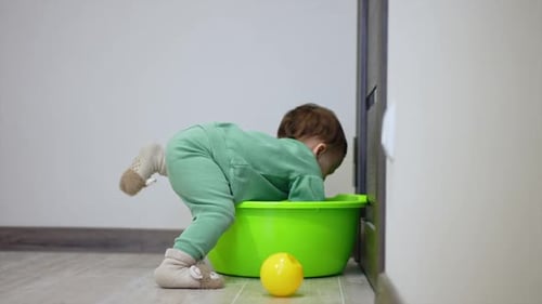 Infant Plays with Bowl in Home Interior