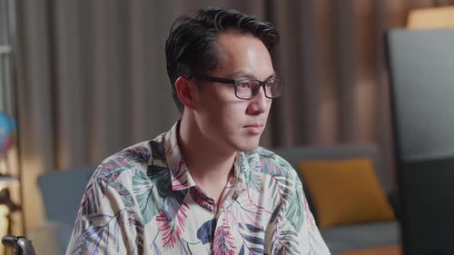 Close Up Of Asian Man In Wheelchair Is Using A Desktop Next To The Camera Editing The Video At Home