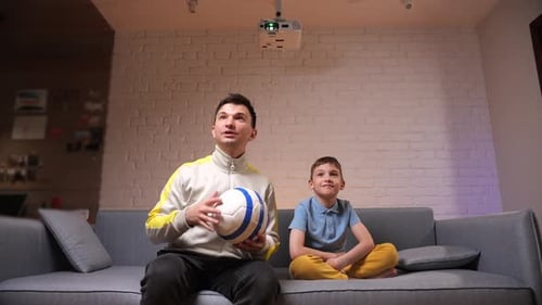 Man and Child Watch Projector with Soccer Ball