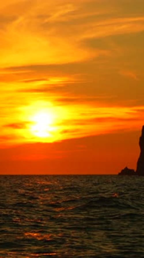 Sunset Ocean Rock Silhouette Vibrant Sunset Over Ocean Silhouetting a Coastal Rock Formation at Dusk