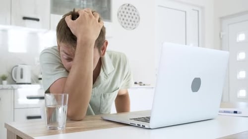 Frustrated Man With Laptop Inside Bright Home