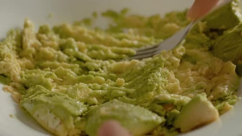 Mashing Avocado With Fork in Bowl for Guacamole