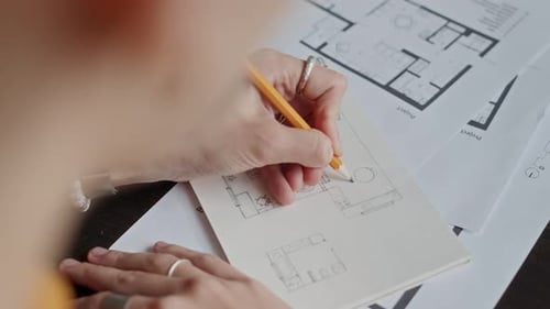 Interior Designer Drawing Floor Plan of Apartment