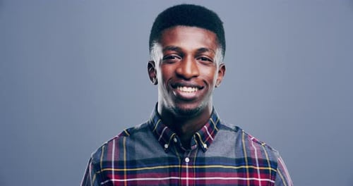 Cheerful Man Smiling and Making Heart Gesture