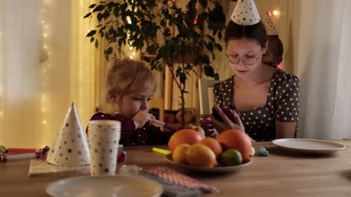 Kids Celebrating Birthday Party Blowing Party Favors Indoors