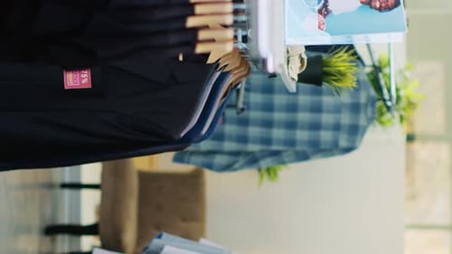 Clothes on Hangers in a Bright Clothing Store