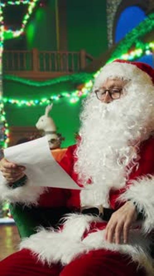 Vertical Video Tired Santa Claus Falling Asleep While Making List of Kids Who Has Been Naughty