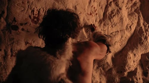 Cave Dweller Making Markings on the Cave Wall