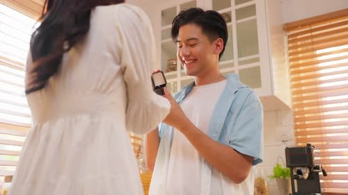 Man Proposes, Woman Accepts Proposal in Kitchen