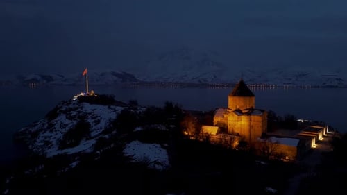 aerial view of a beautiful island with a small church on the hill in the evening in winter