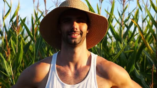 Happy Smiling Male Farmer Looks Into Camera Standing Near Corn Meadow Portrait of Young Handsome