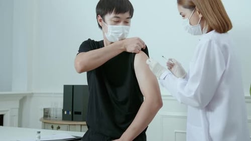 Man Receives Vaccine Injection From Doctor