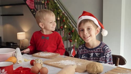 Smiling Children Baking Christmas Cookies at Home