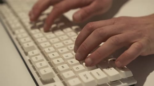 Man Typing on Computer Keyboard Close Up