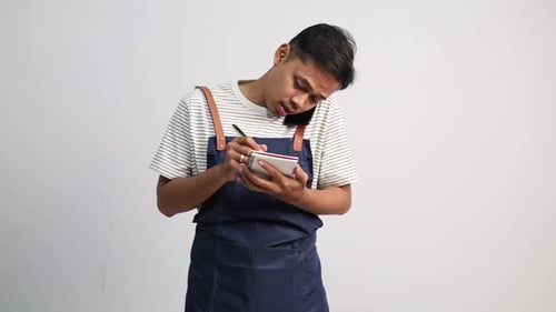 A restaurant or coffee shop waiter communicates by receiving online orders from customers via