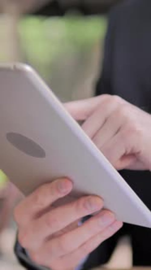 Close up of Man Using Tablet at Work