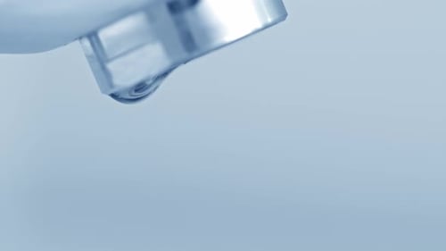 Water Drops from Faucet in Macro Shot