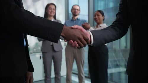 Business Handshake with Colleagues Applauding in Office