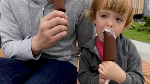 Child and Adult Enjoying Ice Cream Treat Together