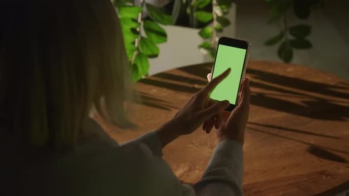 Woman Swipe on a Smart Phone with Green Screen Chroma Key Sideways