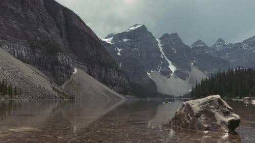 View of the Moraine Lake surface on a rainy cloudy day