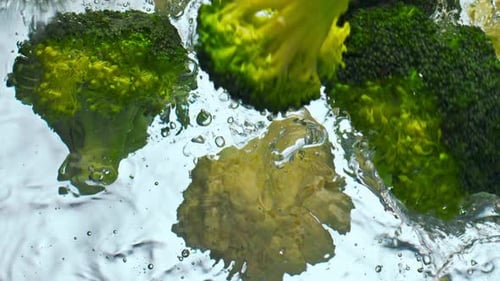 Pieces Broccoli Cauliflower Falling Water in Super Slow Motion Close Up