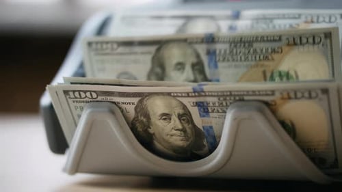 Electronic Counter Calculating Dollar Banknotes Close Up