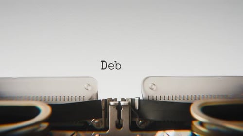 Old mechanical typewriter typing Debit in a close-up view.