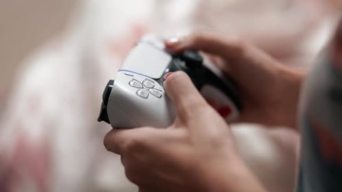Person Playing Video Game with Controller Close Up